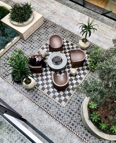 an overhead view of a patio with chairs and plants