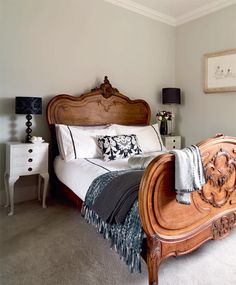 a bedroom with a bed, nightstands and pictures on the wall