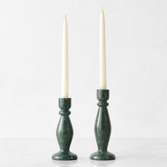 two candles sitting next to each other on a table