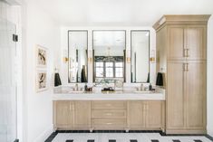 a large bathroom with double sinks and mirrors