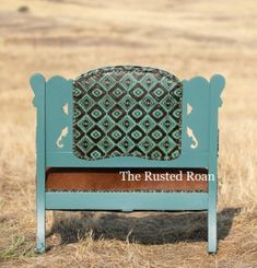 the rusted roam sign is in an open field with dry grass and tall grasses