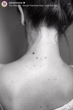 the back of a woman's neck with small stars on it