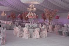 a banquet hall decorated in pink and white