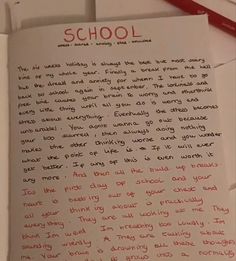 a piece of paper with writing on it next to a red marker and pencils