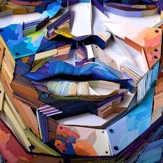 an abstract painting made out of colored papers and paper machs on top of each other