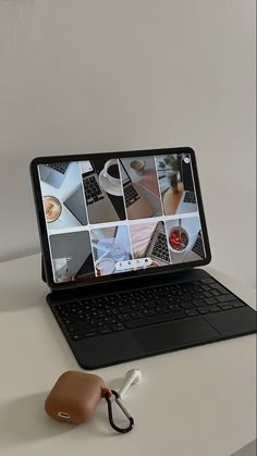 an open laptop computer sitting on top of a white desk next to a mouse and keyboard