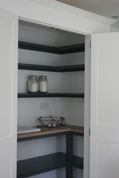 an empty pantry with two jars on the counter