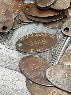 lots of old metal tags with numbers on them