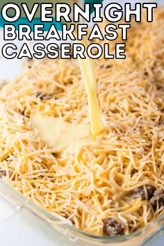 a casserole dish with cheese being poured over it and the words overnight breakfast casserole on top