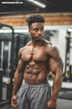 a man with no shirt standing in front of a gym machine