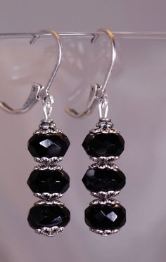 Black Vintage Style Earrings with Silver Filigree Accents. That are 1 1/2 inches long. All orders come in a gift box or a gift bag. Classic Handmade Earrings For Party, Elegant Party Clip-on Earrings With Round Beads, Elegant Round Bead Clip-on Earrings For Party, Elegant Adjustable Plug Earrings For Party, Elegant Sterling Silver Crystal Earrings With Round Beads, Elegant Sterling Silver Beaded Earrings Nickel Free, Elegant Sterling Silver Nickel-free Beaded Earrings, Elegant Nickel-free Beaded Sterling Silver Earrings, Elegant Adjustable Crystal Earrings With Ear Wire