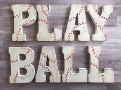 the word play ball spelled with baseball stitches