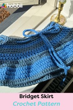 a blue crochet skirt sitting on top of a counter