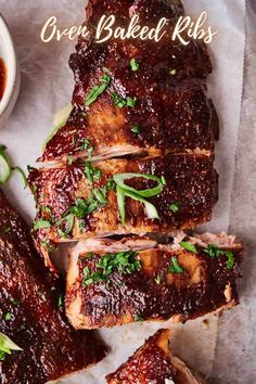 barbecue ribs on parchment paper with sauce and herbs