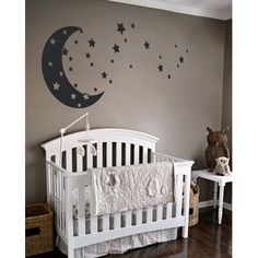 a baby's room with a crib and stars on the wall