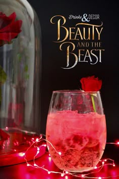 a pink drink in a wine glass with a red rose on the rim and an advertisement for beauty and the beast behind it