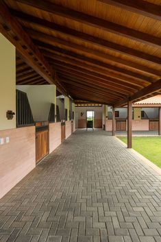 the walkway is lined with brick tiles and wooden posts, leading to an enclosed courtyard