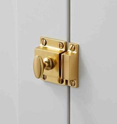 a close up of a door handle on a white and gold door with two knobs