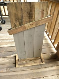 a wooden planter sitting on top of a wooden deck