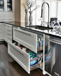 an open dishwasher drawer in a kitchen