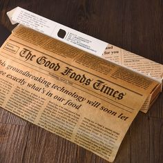 an old newspaper laying on top of a wooden table