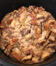 a crock pot filled with bread and stuffing