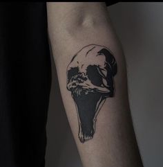 a black and white photo of a skull on the arm