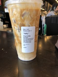 a plastic cup filled with liquid sitting on top of a table