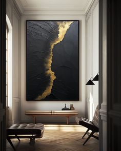 a large black and gold painting hanging on the wall above a bench in a living room