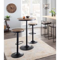 two stools and a table with a clock on the wall behind it in a living room