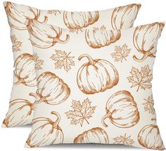 two decorative pillows with pumpkins and leaves on them, one is white and the other is orange