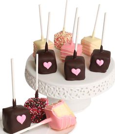 there are many different types of chocolates on the cake plate and one is pink