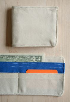 an empty wallet with one dollar bill sticking out of the front and another in the back