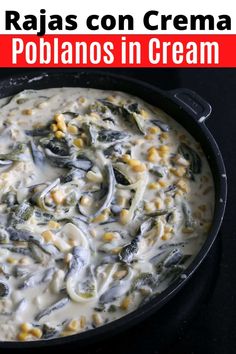 a skillet filled with cream and vegetables on top of a table next to a red sign