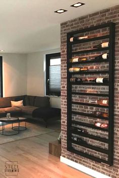 a living room filled with furniture and a brick wall next to a large open window