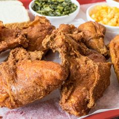 fried chicken and other foods on a red tray