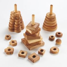 several wooden toys are arranged on a white surface, including one stacking toy and the other