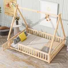 a child's bed with a wooden frame and mattress on the bottom floor in front of a striped wall