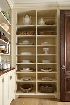 an open pantry with plates and bowls in it