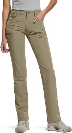 a woman is standing with her hands on her hips and wearing khaki pants