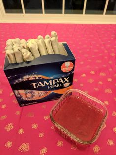 a box of tampax toothpicks sitting next to a container of sauce