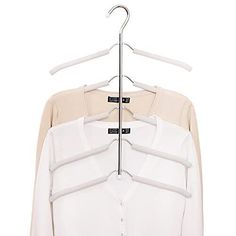 a white shirt is hanging on a metal hanger with two clips attached to it