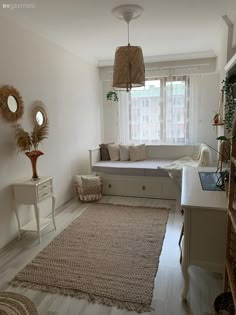 a living room filled with furniture and a large rug on top of a hard wood floor