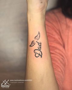 a woman's wrist tattoo with the word love written in cursive writing