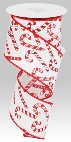 a roll of red and white ribbon with candy canes printed on it's side