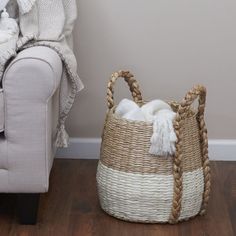 a basket sitting on the floor next to a couch