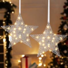 two white stars are hanging from the ceiling