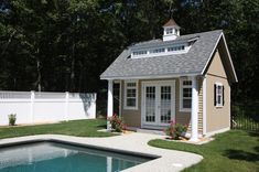 a small pool house next to a swimming pool