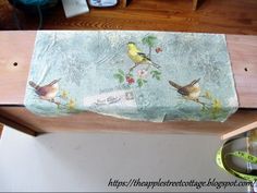 a piece of wood with birds painted on it