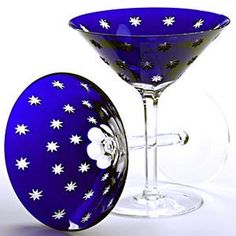 a blue glass with white stars on it and a wine glass holder next to it